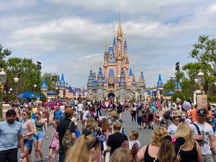 Crowds outside Cinderella Castle at Magic Kingdom during peak season