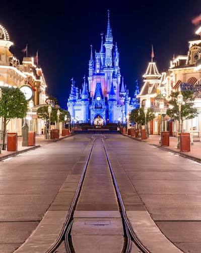 Empty Main Street USA at night with Cinderella Castle illuminated